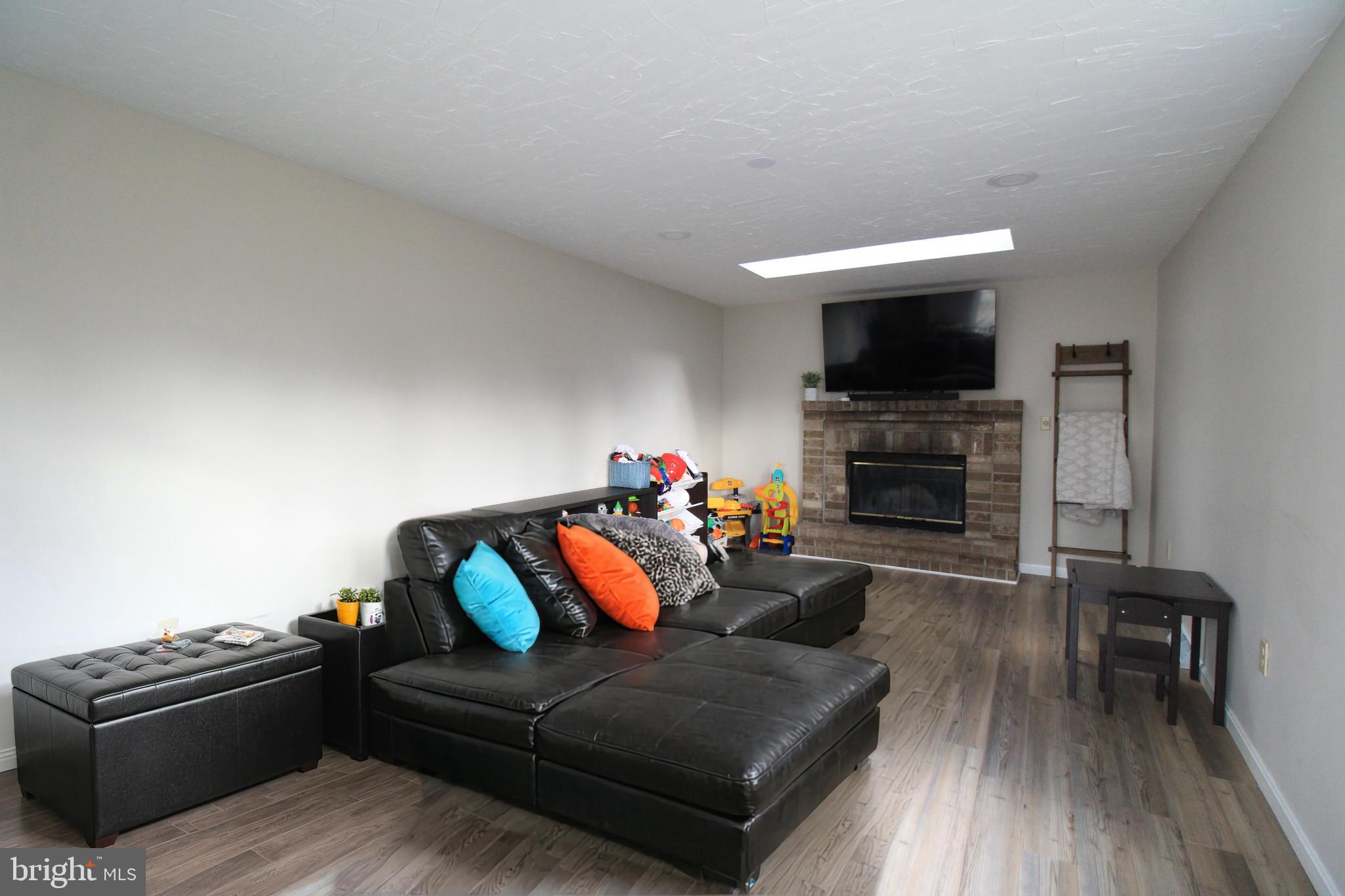 2582 Abby Lane Dover, PA 17315 - Photo 13 of 22 a living room with furniture a flat screen tv and a fireplace