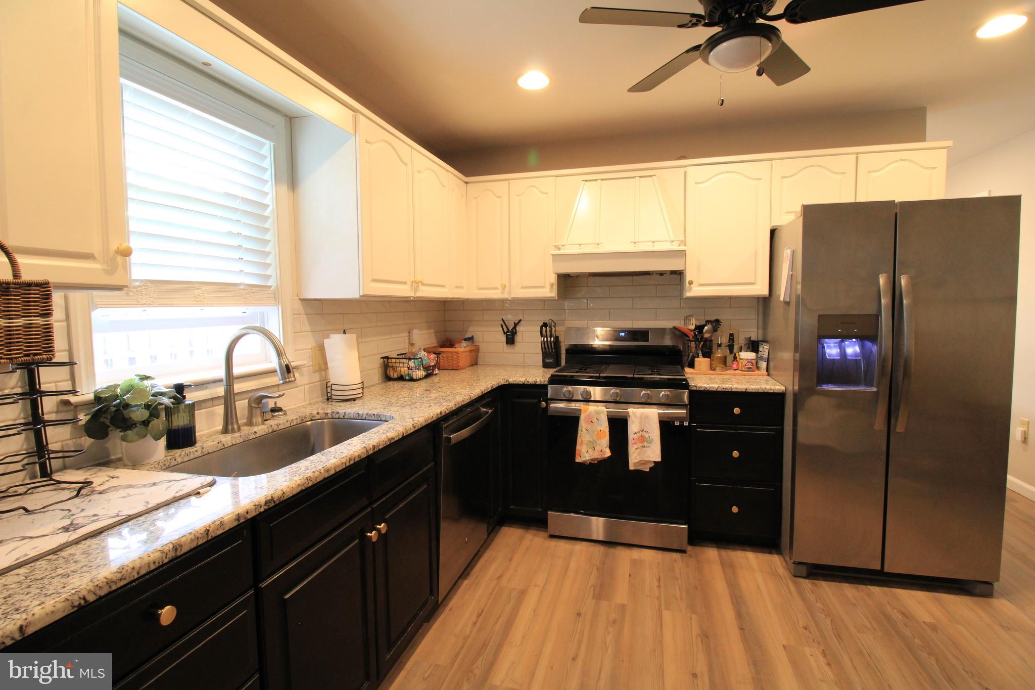 2582 Abby Lane Dover, PA 17315 - Photo 15 of 22 a kitchen with granite countertop a refrigerator a sink a stove and cabinets