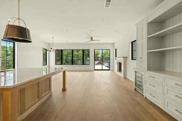 a view of an empty room with window and cabinet