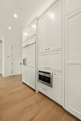 a view of an empty room with a kitchen