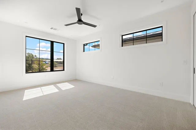 a view of an empty room with windows