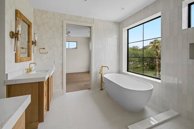 a spacious bathroom with a bathtub and window