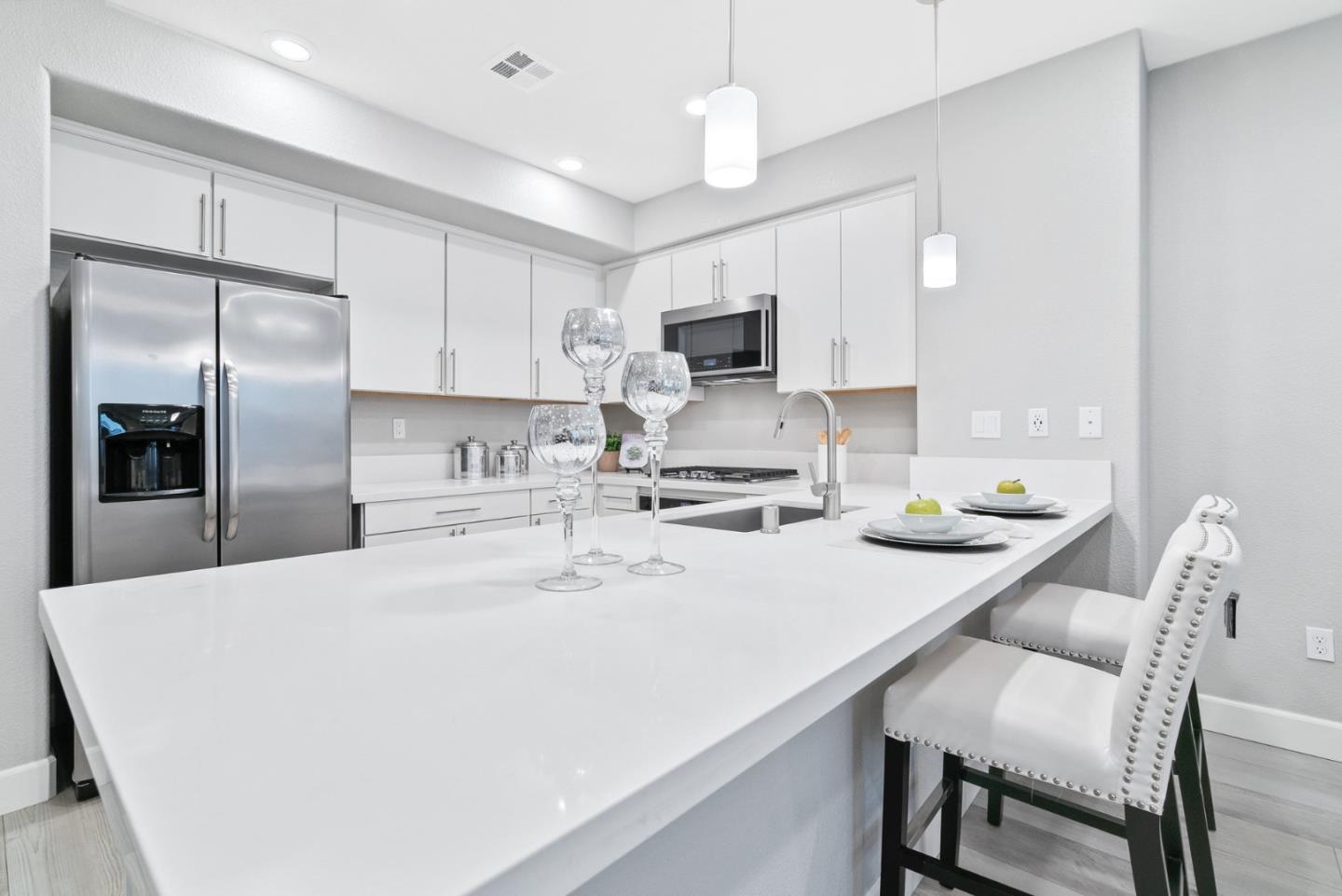 633 Clover Circle Milpitas, CA 95035 - Photo 11 of 36 a kitchen with kitchen island a sink stove and refrigerator