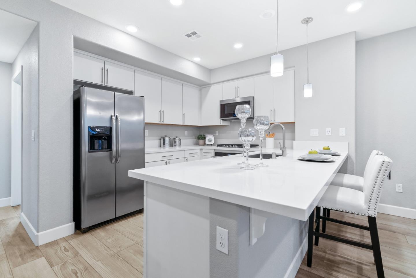 633 Clover Circle Milpitas, CA 95035 - Photo 12 of 36 a kitchen with stainless steel appliances a refrigerator sink and microwave