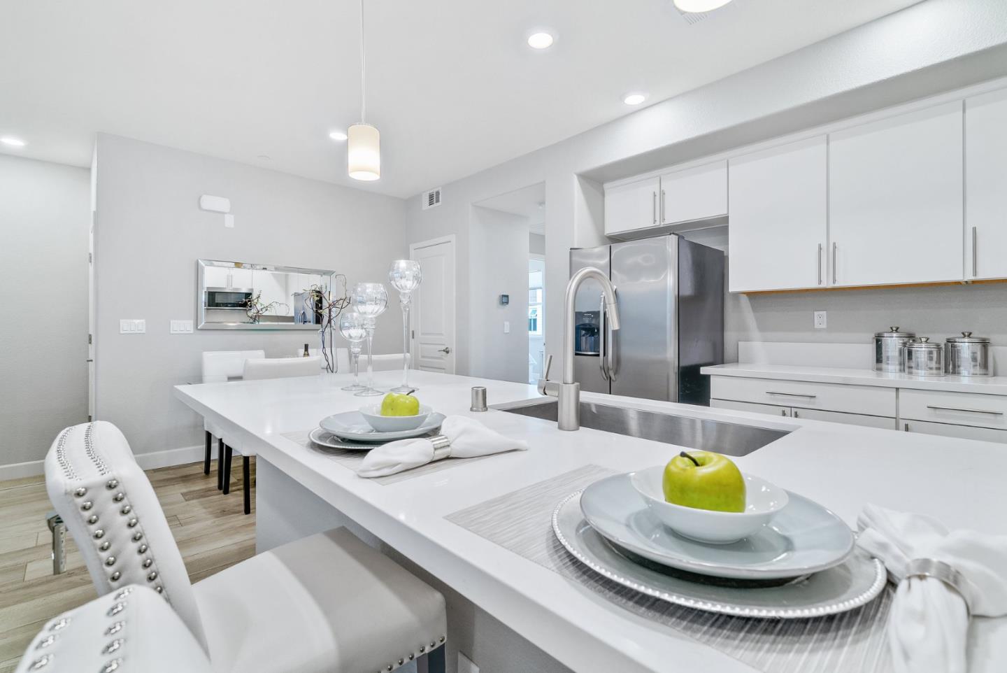 633 Clover Circle Milpitas, CA 95035 - Photo 13 of 36 a kitchen with stainless steel appliances kitchen island granite countertop a dining table chairs and a sink