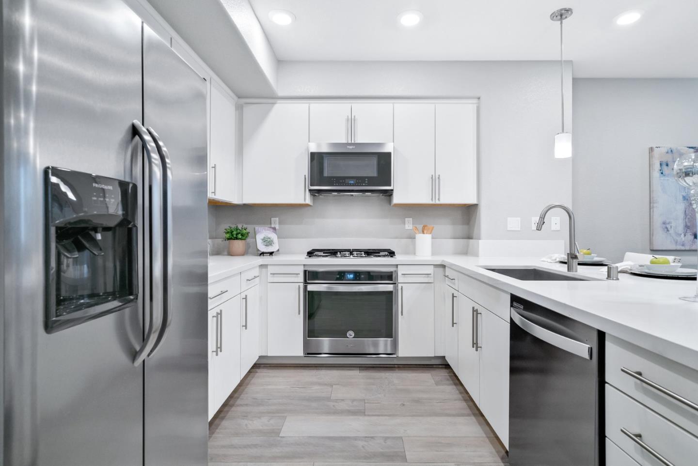 633 Clover Circle Milpitas, CA 95035 - Photo 14 of 36 a kitchen with stainless steel appliances granite countertop a stove a sink and a refrigerator