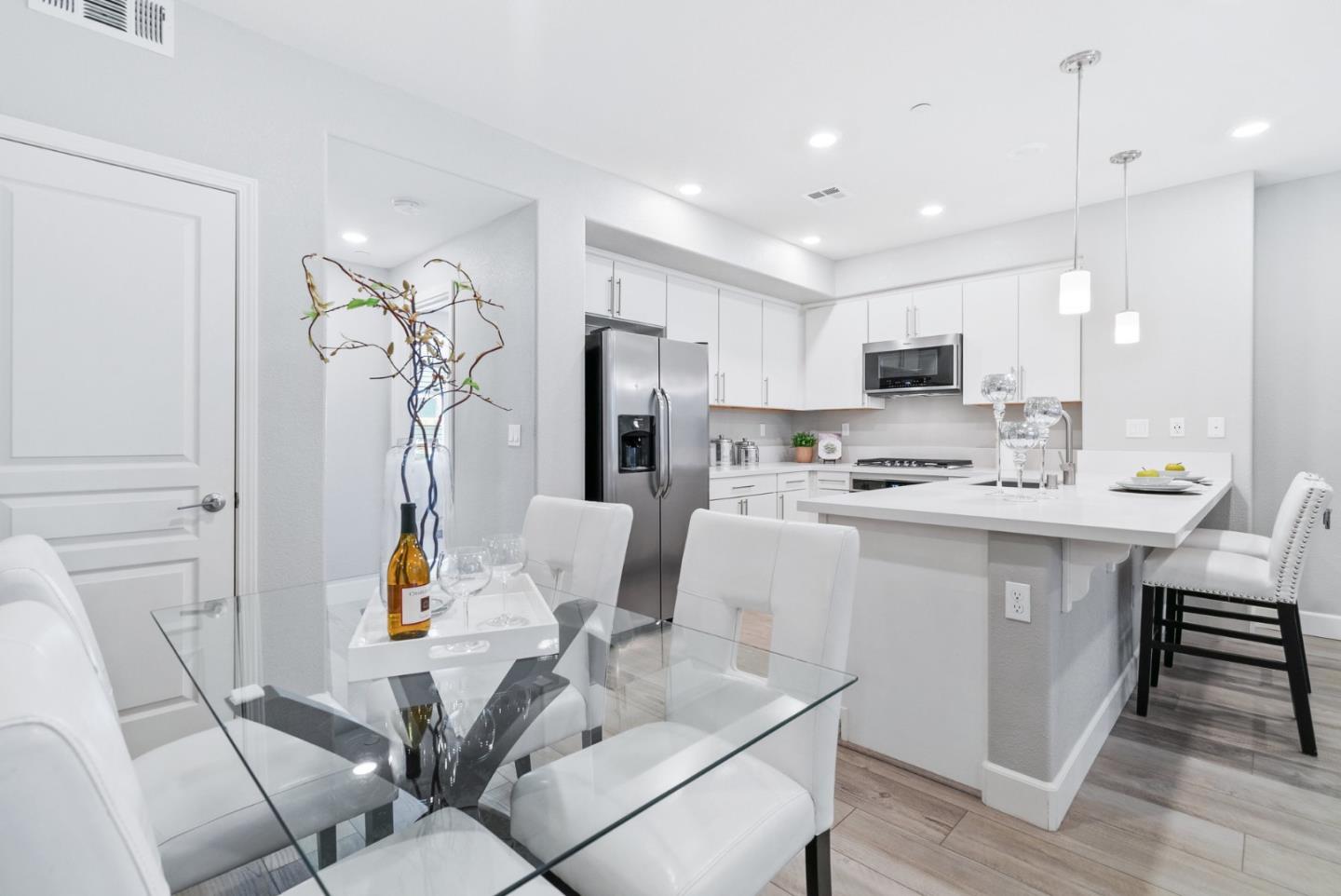 633 Clover Circle Milpitas, CA 95035 - Photo 17 of 36 a kitchen with stainless steel appliances granite countertop a sink a stove a dining table and chairs