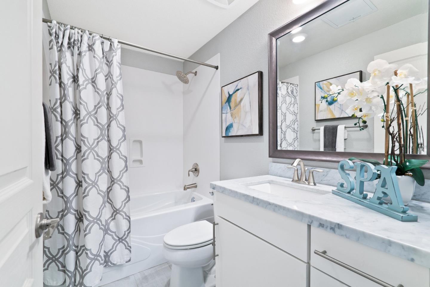 633 Clover Circle Milpitas, CA 95035 - Photo 25 of 36 a bathroom with a sink a toilet and shower curtain