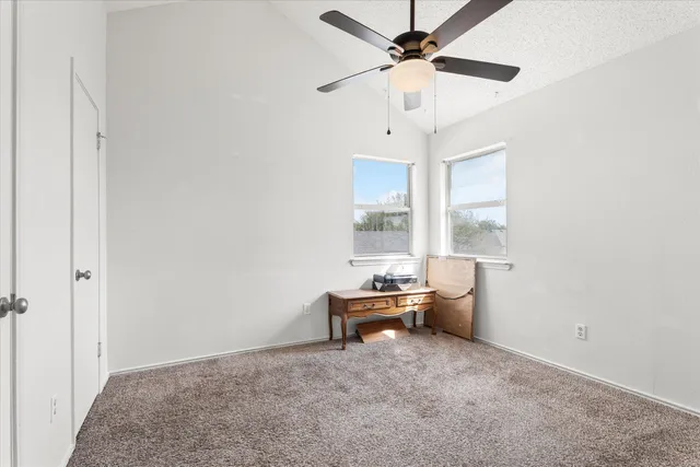a room with a window and a ceiling fan
