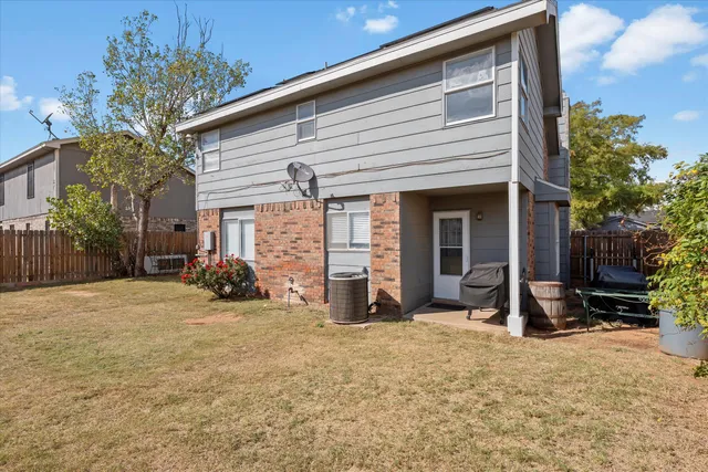 a view of a house with backyard and porch
