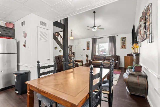 a view of a dining room with furniture and a chandelier