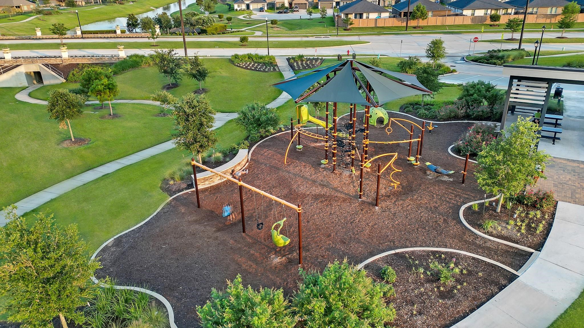 31423 Harp Ridge Drive Fulshear, TX 77441 - Photo 41 of 45 Discover a vibrant community playground featuring modern equipment and shaded areas, nestled within lush green surroundings and winding walking paths. Perfect for family fun and outdoor activities.