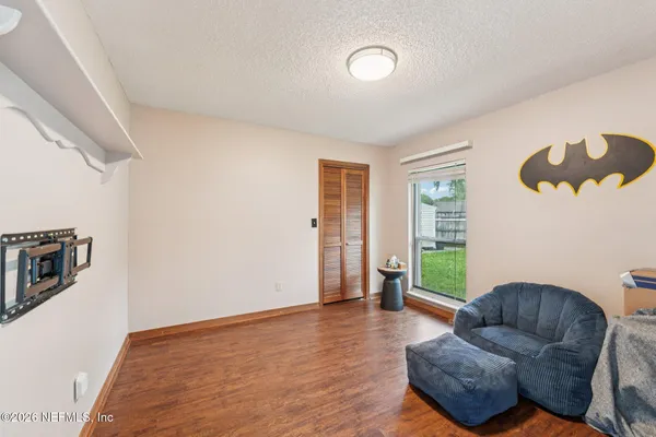 a dining room with furniture and wooden floor