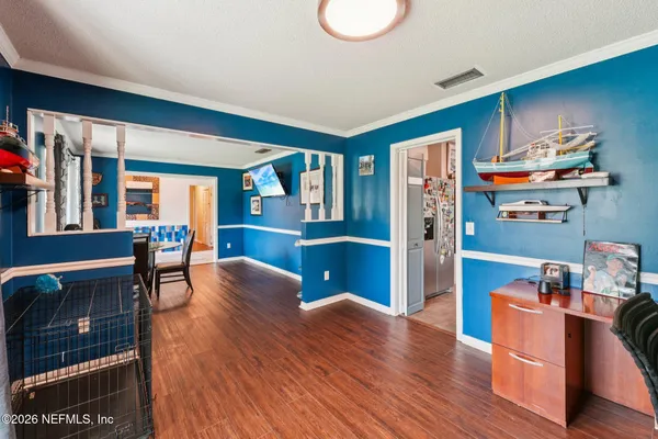 a kitchen with stainless steel appliances kitchen island granite countertop a table chairs sink and cabinets
