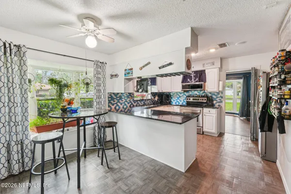 a kitchen with stainless steel appliances granite countertop a sink and a stove top oven