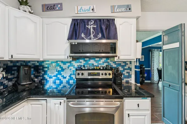 a living room with furniture pool table and window