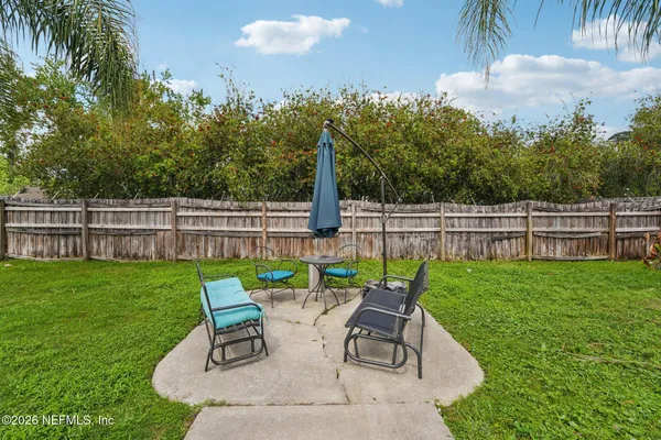 a view of backyard with a garden and entertaining space