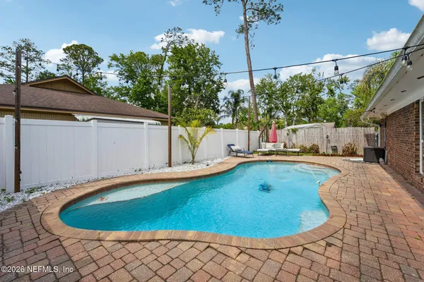 a view of a house with swimming pool and yard