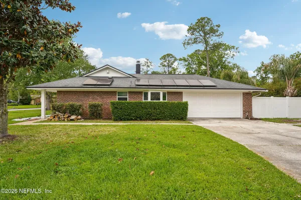 a front view of a house with a yard and porch