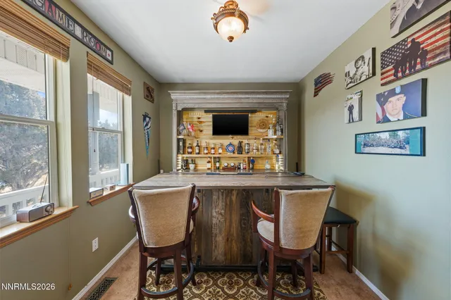 a bedroom with a bed a chandelier and flat screen tv