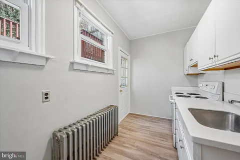 a view of a kitchen with sink and cabinets