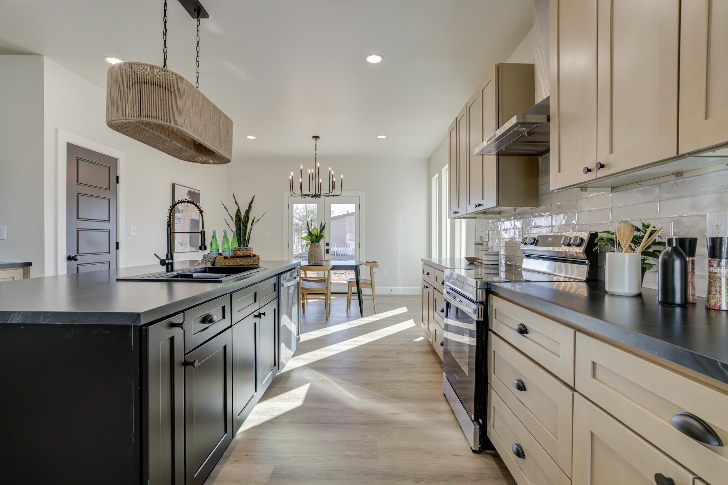 305 Southwest Ave L Seminole, TX 79360 - Photo 15 of 52 a kitchen with stainless steel appliances a sink a stove and chairs