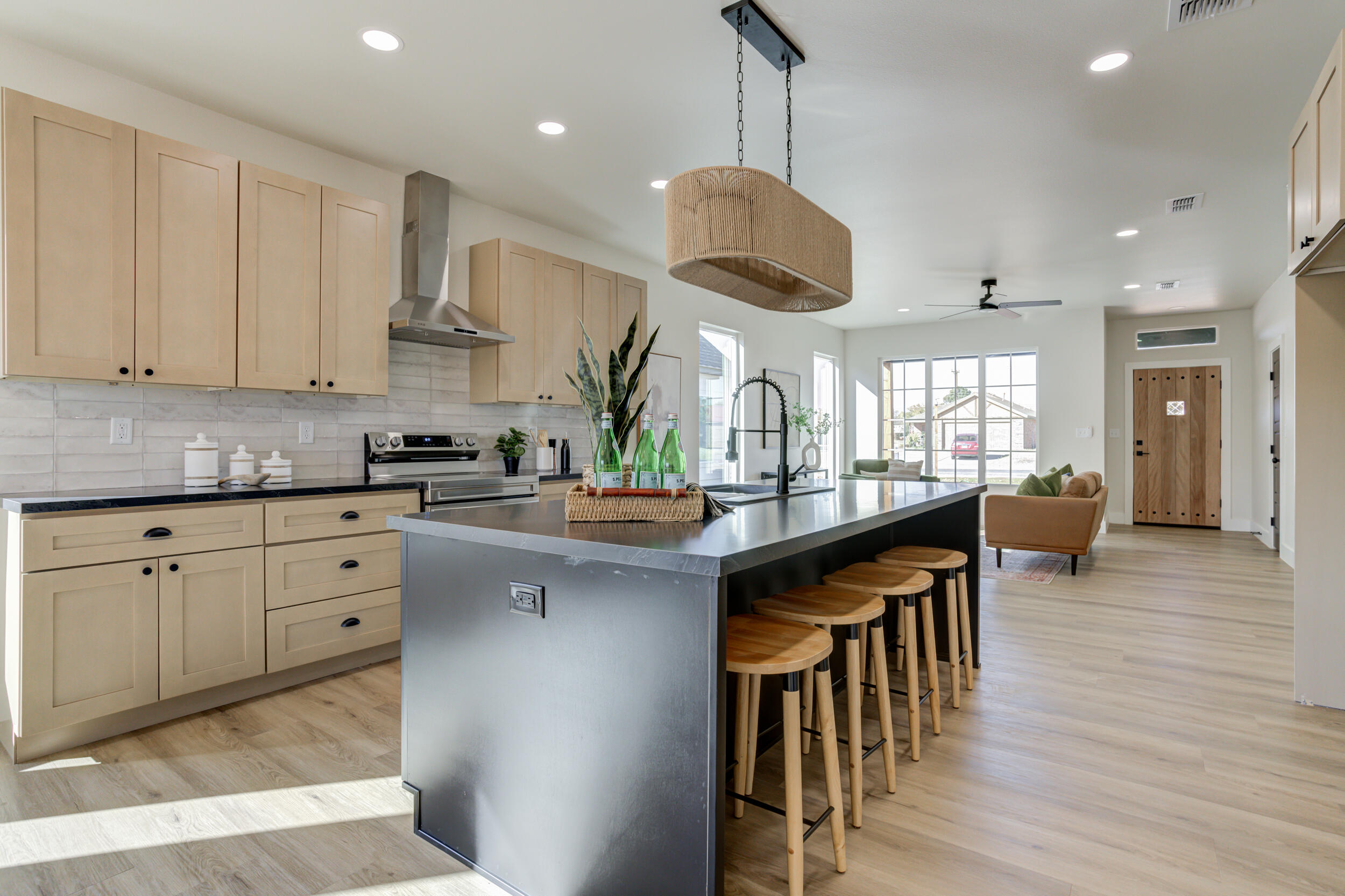 305 Southwest Ave L Seminole, TX 79360 - Photo 22 of 52 a kitchen with stainless steel appliances granite countertop a sink a stove and a wooden floors