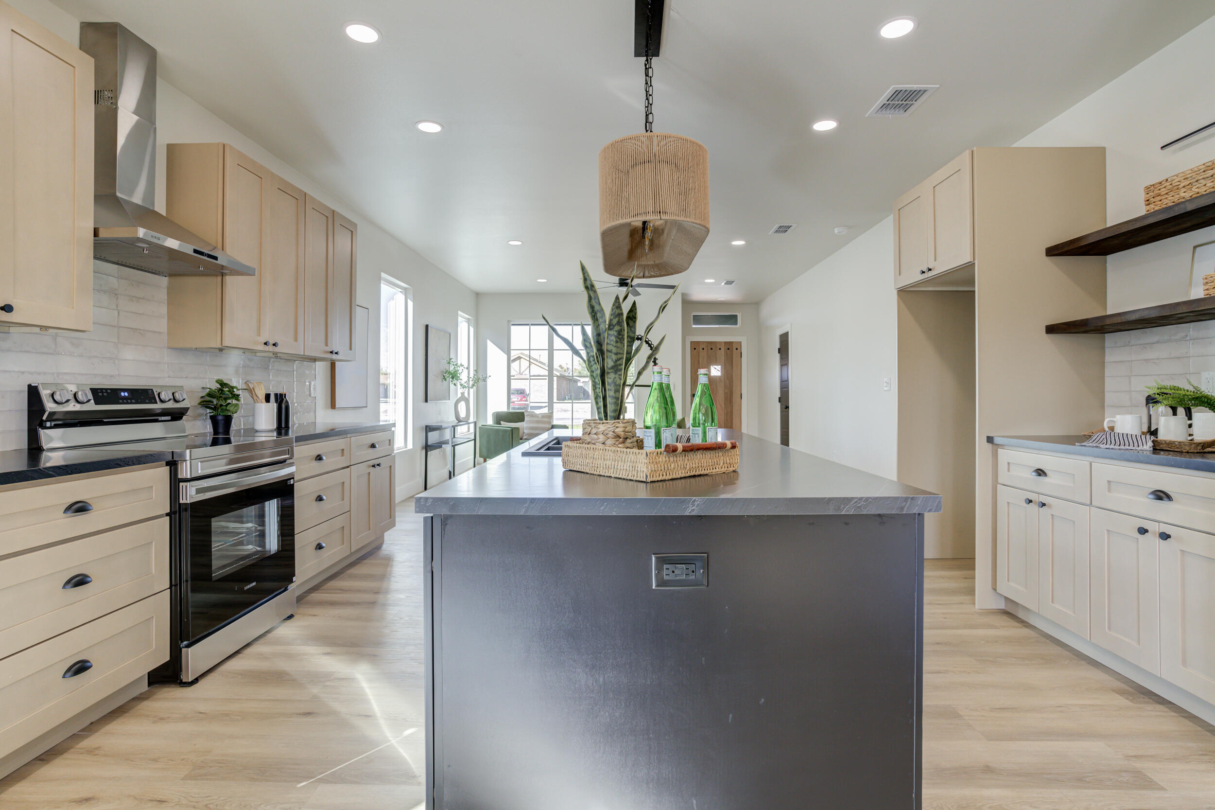 305 Southwest Ave L Seminole, TX 79360 - Photo 23 of 52 a kitchen with stainless steel appliances granite countertop a sink a stove and a refrigerator