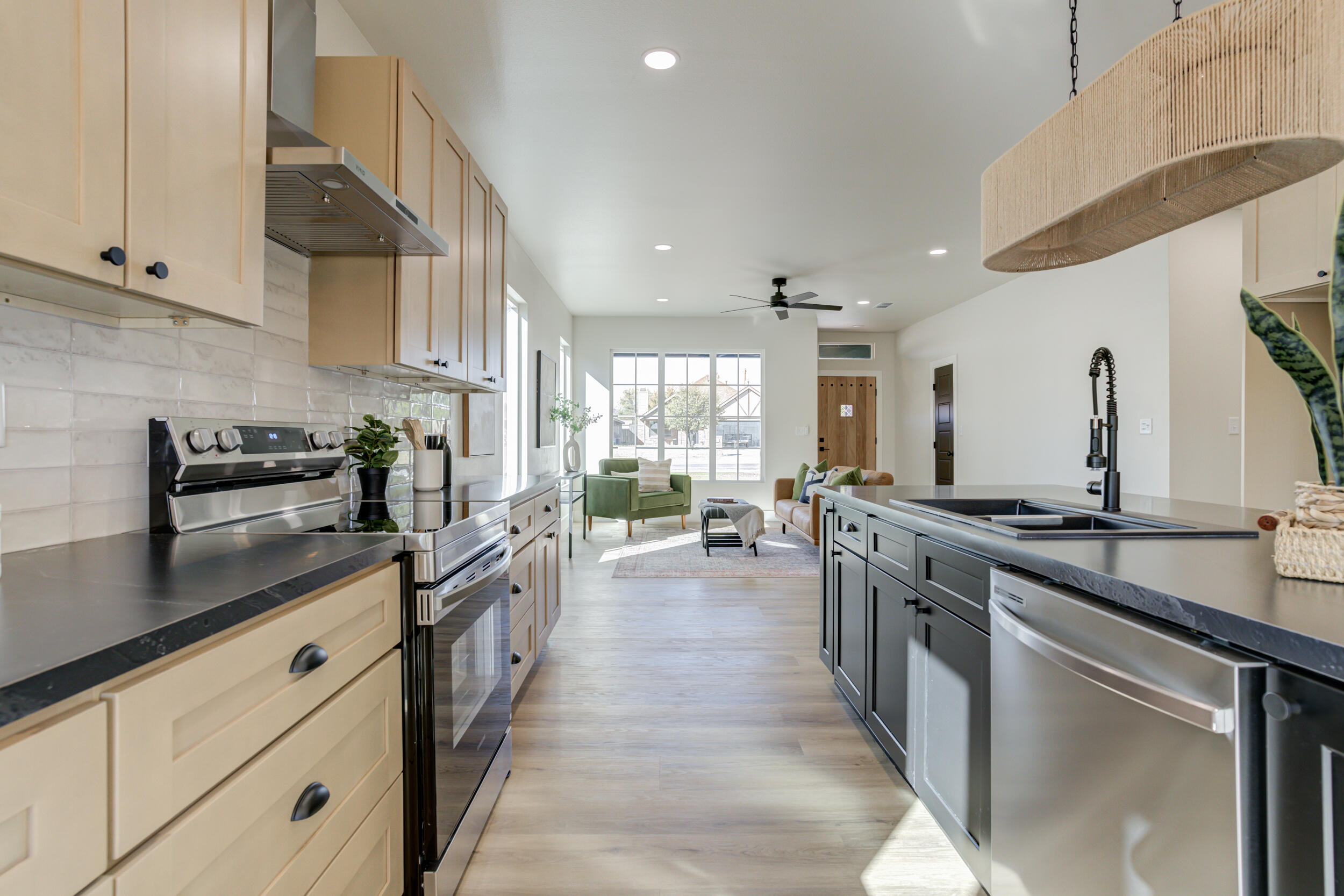 305 Southwest Ave L Seminole, TX 79360 - Photo 25 of 52 a kitchen with stainless steel appliances granite countertop a stove and a sink