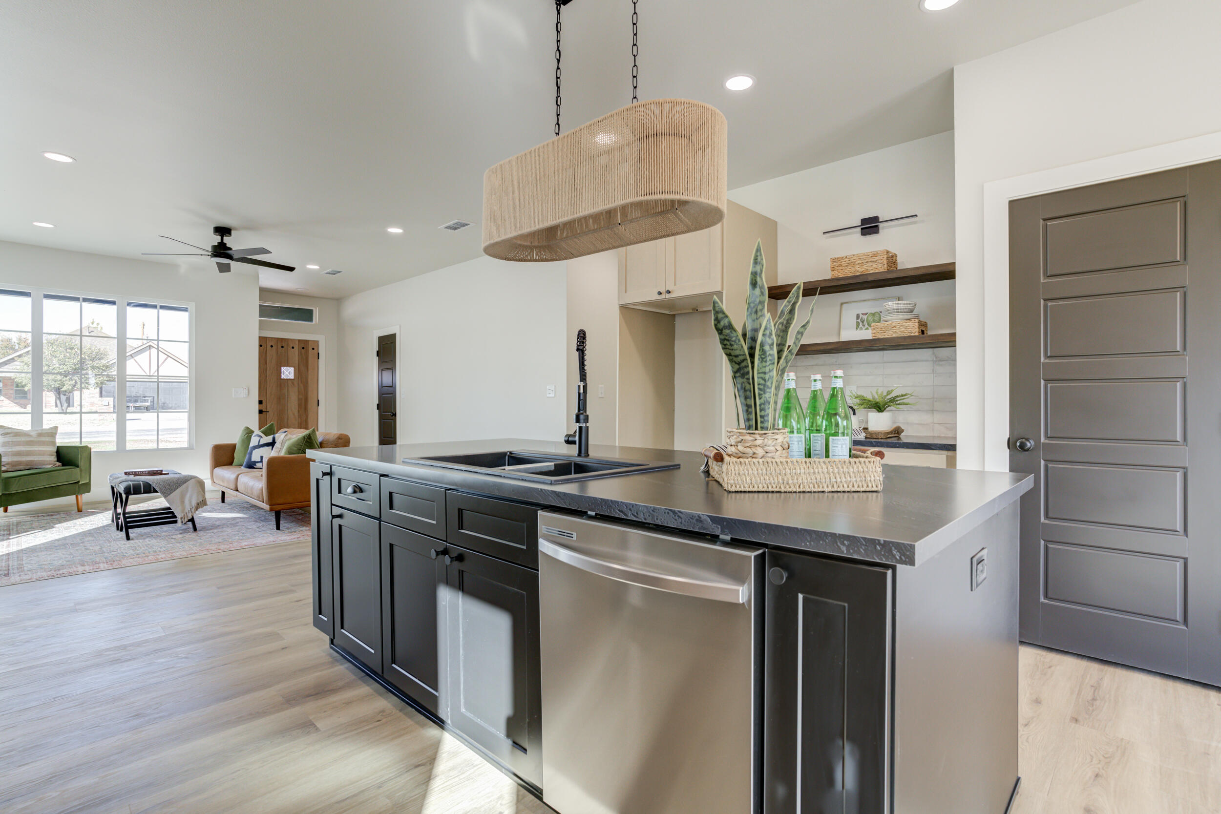 305 Southwest Ave L Seminole, TX 79360 - Photo 26 of 52 a kitchen with stainless steel appliances granite countertop a sink a stove and a wooden floors