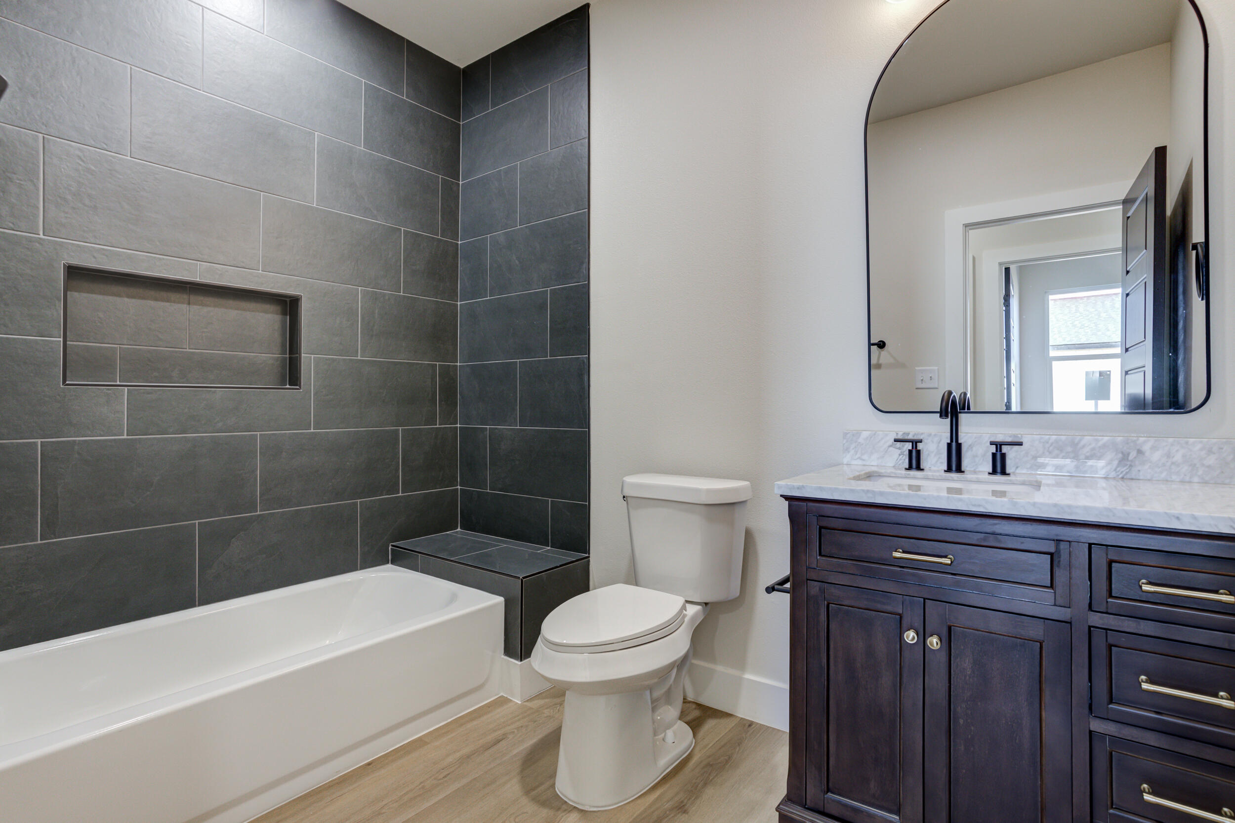 305 Southwest Ave L Seminole, TX 79360 - Photo 32 of 52 a bathroom with a bathtub shower sink mirror and toilet