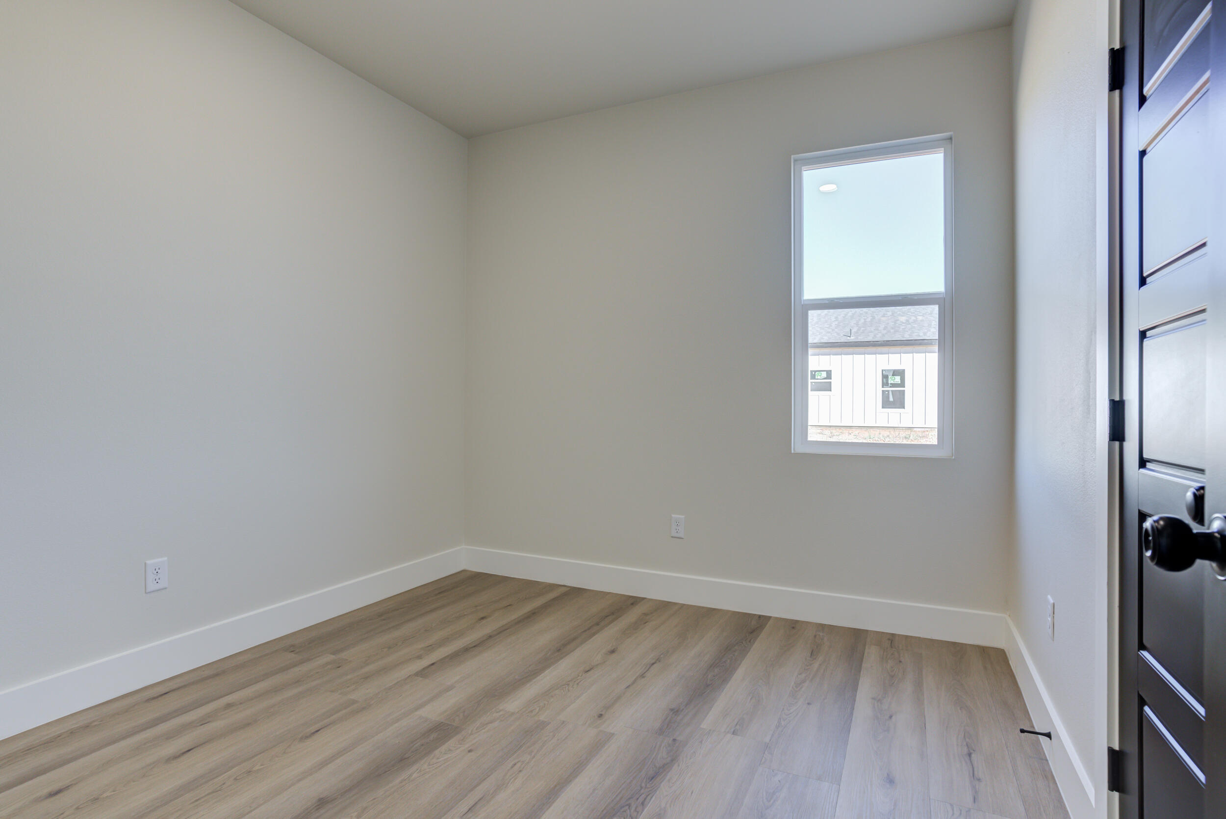 305 Southwest Ave L Seminole, TX 79360 - Photo 34 of 52 a view of an empty room with wooden floor and a window