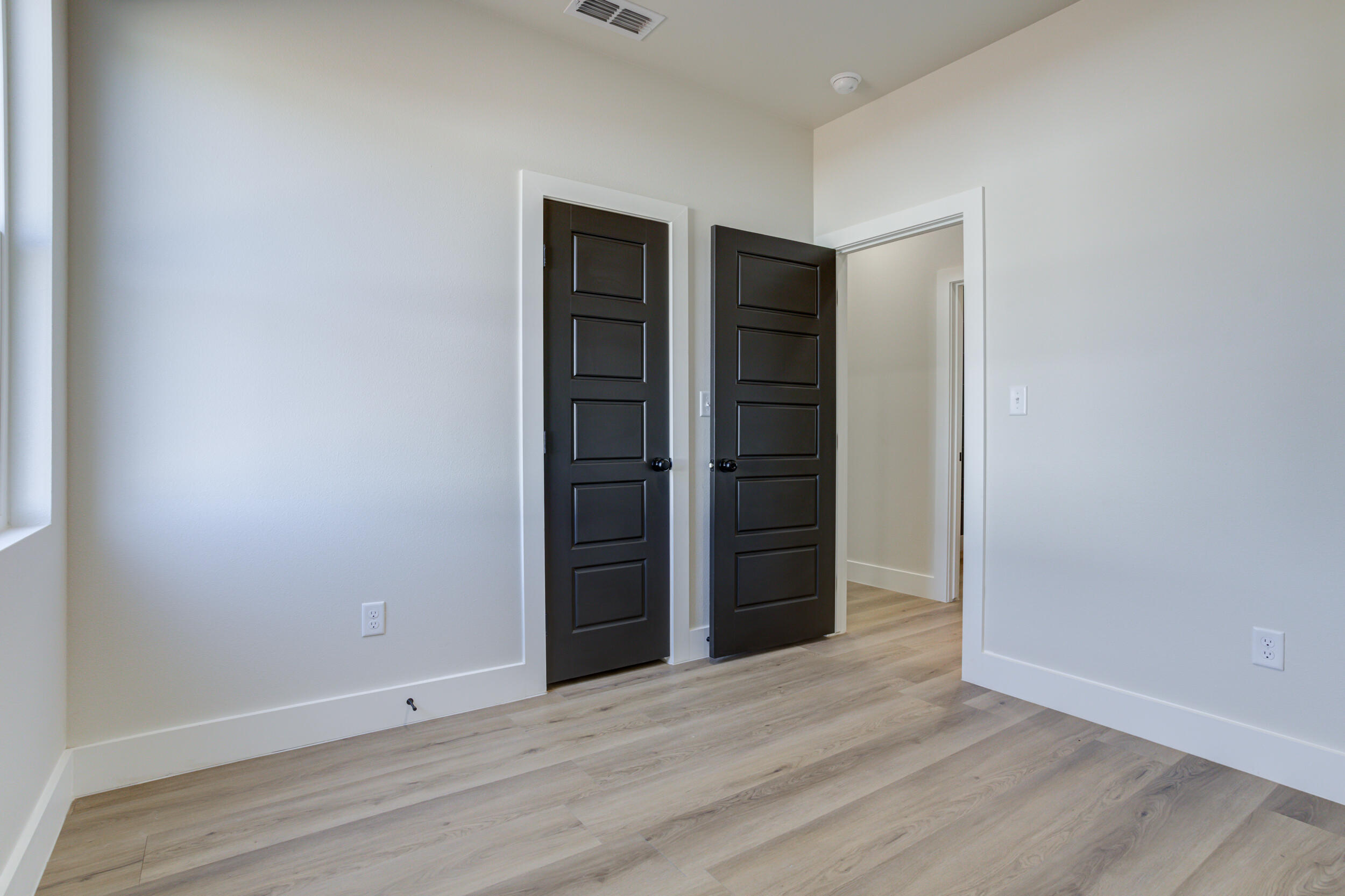 305 Southwest Ave L Seminole, TX 79360 - Photo 35 of 52 a view of an empty room with wooden floor