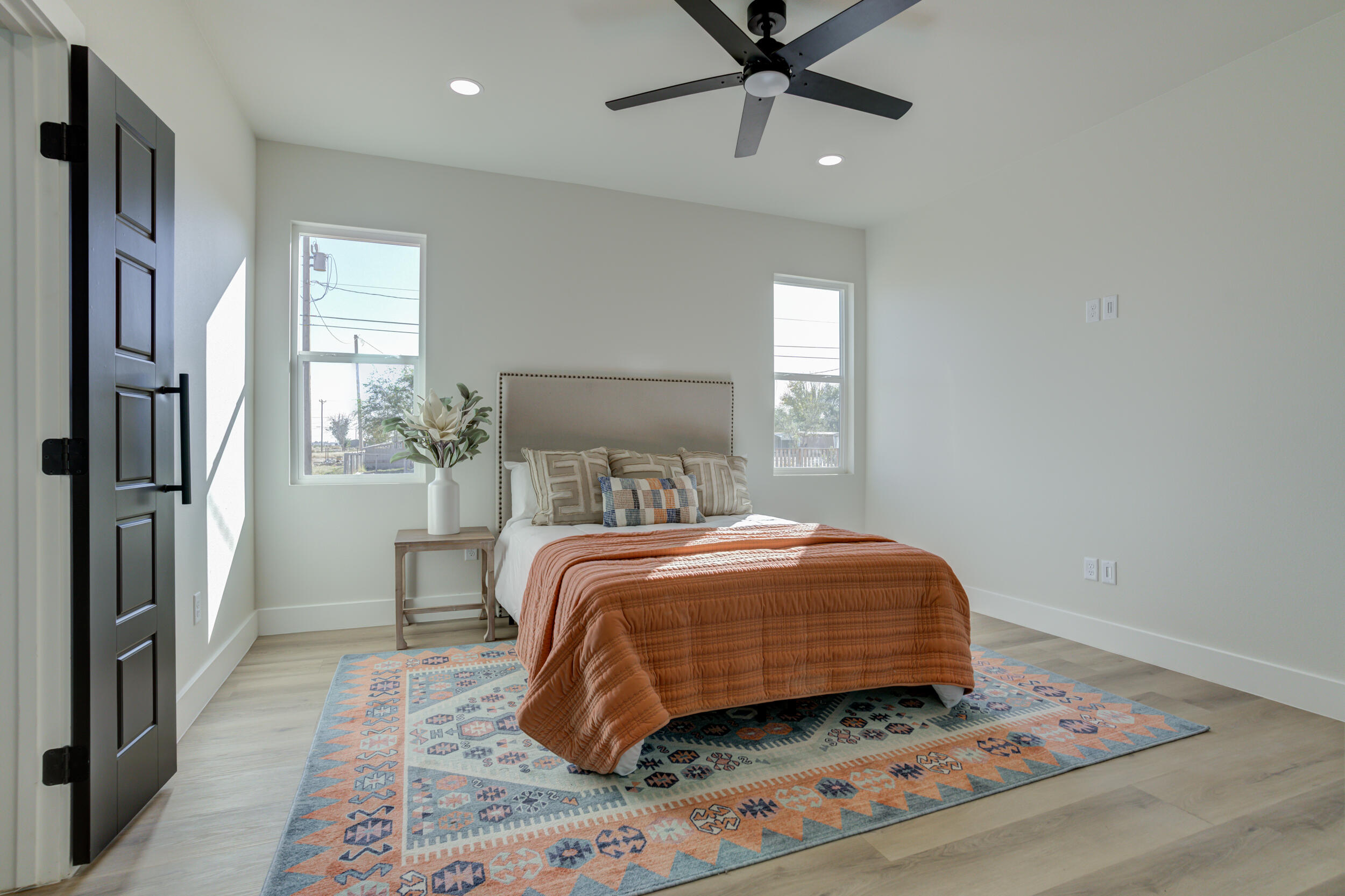 305 Southwest Ave L Seminole, TX 79360 - Photo 38 of 52 a bedroom with a bed and wooden floor