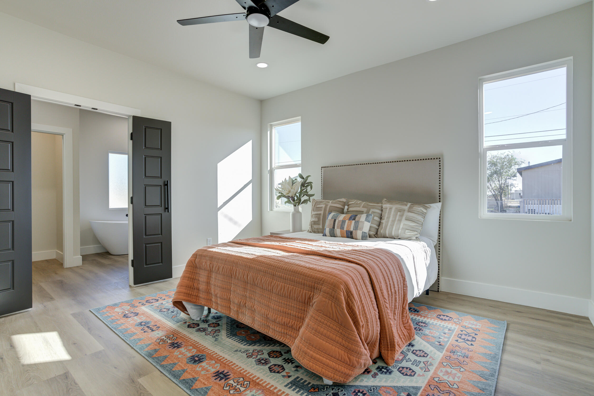 305 Southwest Ave L Seminole, TX 79360 - Photo 39 of 52 a bedroom with a large bed and a chandelier