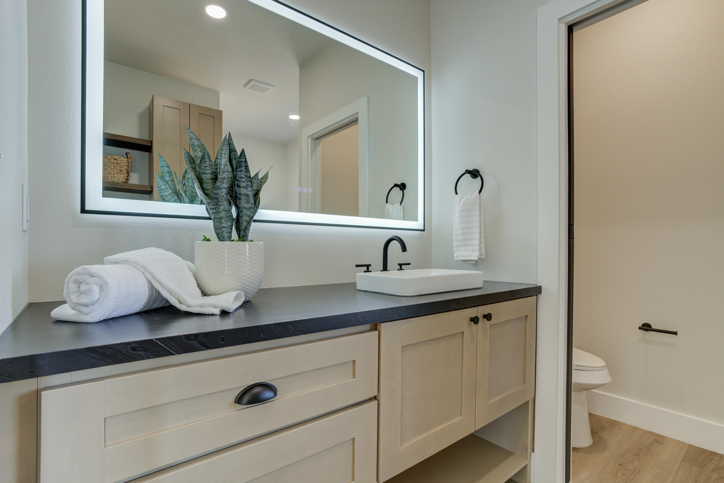 305 Southwest Ave L Seminole, TX 79360 - Photo 44 of 52 a bathroom with a granite countertop sink a mirror and vanity