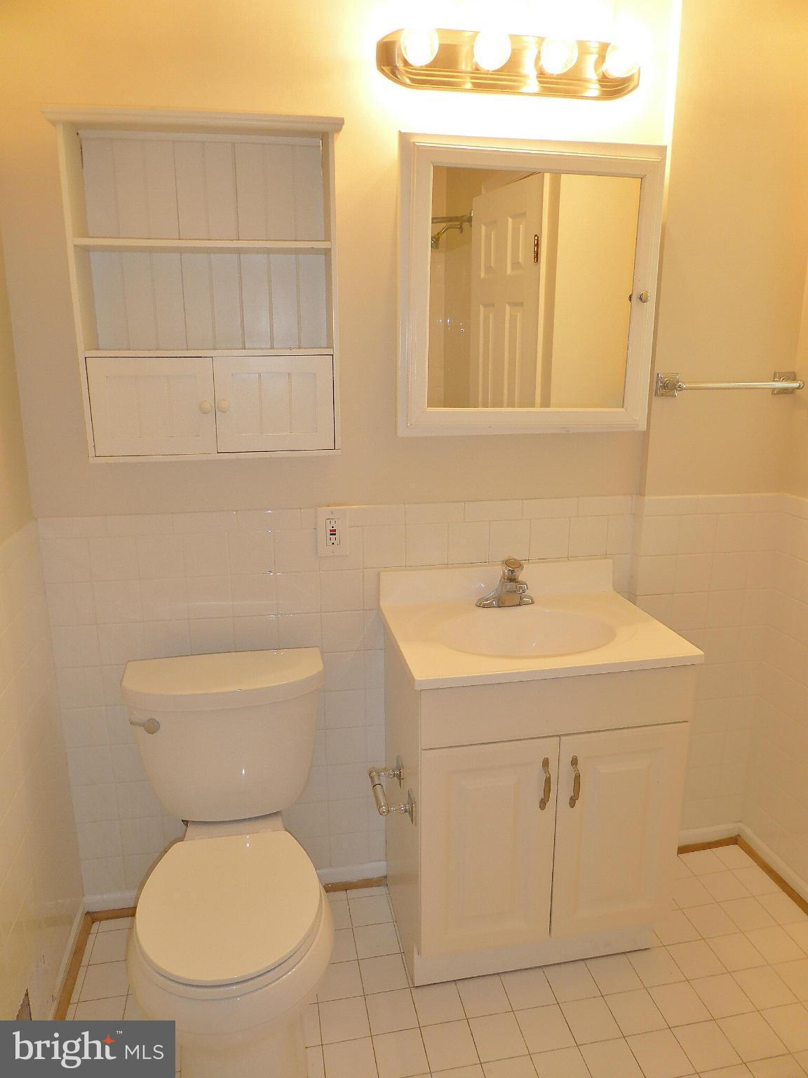 5208 Heming Avenue Springfield, VA 22151 - Photo 8 of 20 a bathroom with a toilet a sink and a window