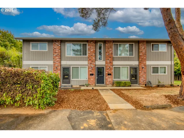 a front view of a house with a garden