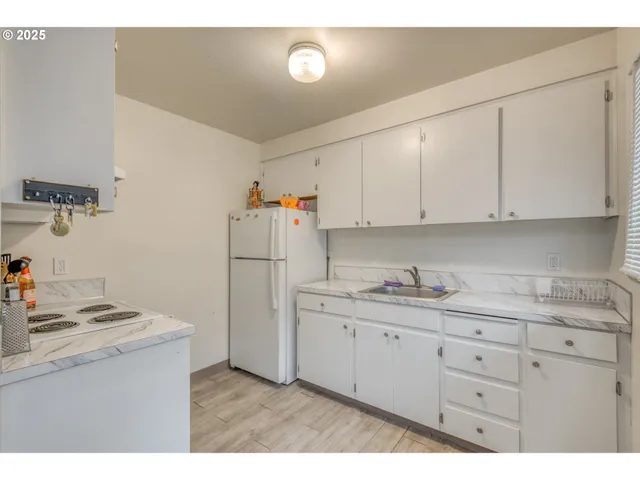 a kitchen with cabinets appliances and a counter top space