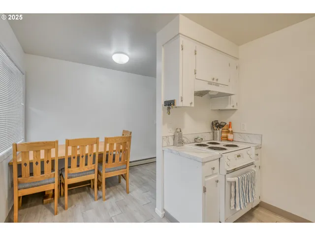 a kitchen that has a table and chairs in it