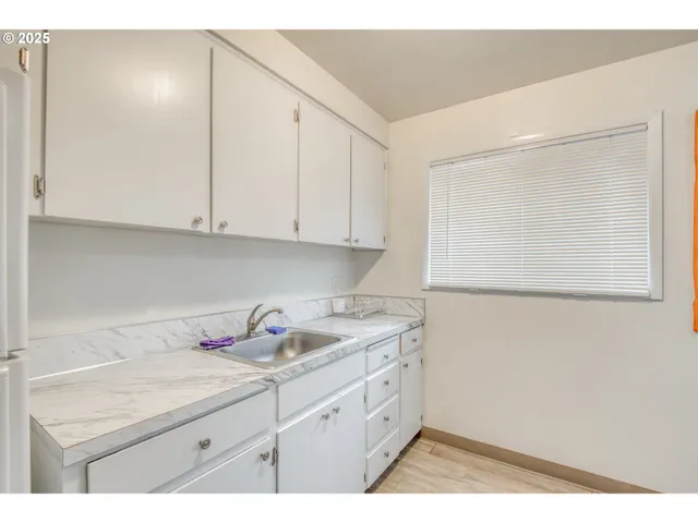 a kitchen with a sink and cabinets