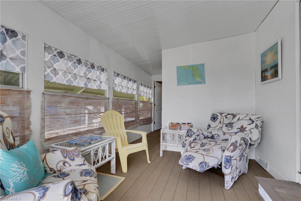 143 Moorhead Manor, Unit 143 Naples, FL 34112 - Photo 11 of 35 Sunroom with a deck