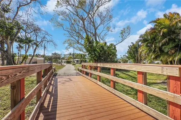 a view of balcony with wooden floor and fence