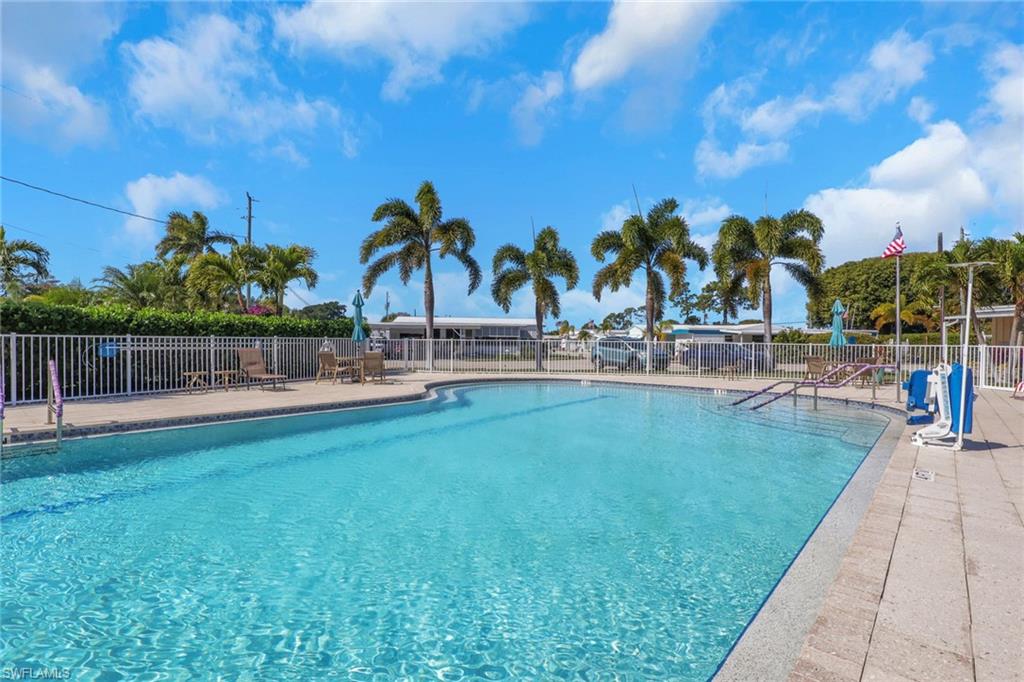 143 Moorhead Manor, Unit 143 Naples, FL 34112 - Photo 28 of 35 Community pool with a patio area