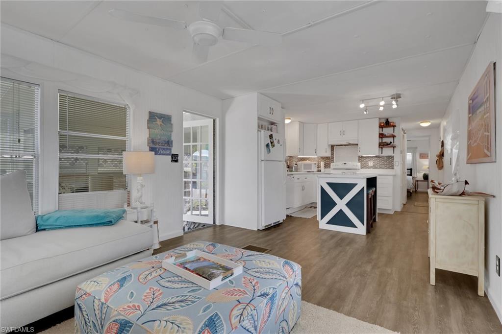 143 Moorhead Manor, Unit 143 Naples, FL 34112 - Photo 3 of 35 Living area with light wood-style flooring and ceiling fan