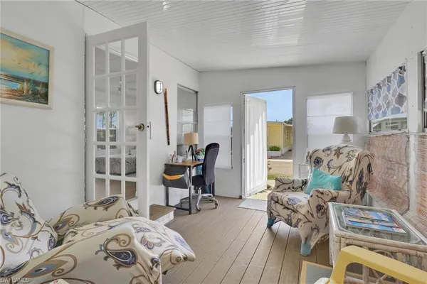 a bedroom with furniture and a wooden floor
