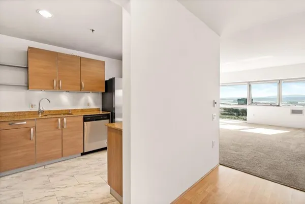 a kitchen with stainless steel appliances granite countertop a refrigerator and a sink