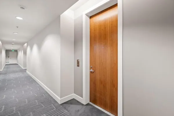 a view of a hallway with wooden floor