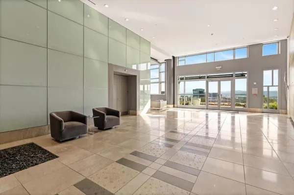 a hallway with a couch and chandelier