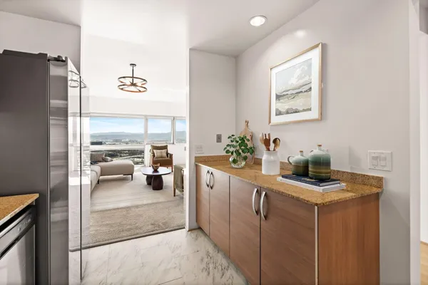 a kitchen that has a lot of furniture and a refrigerator